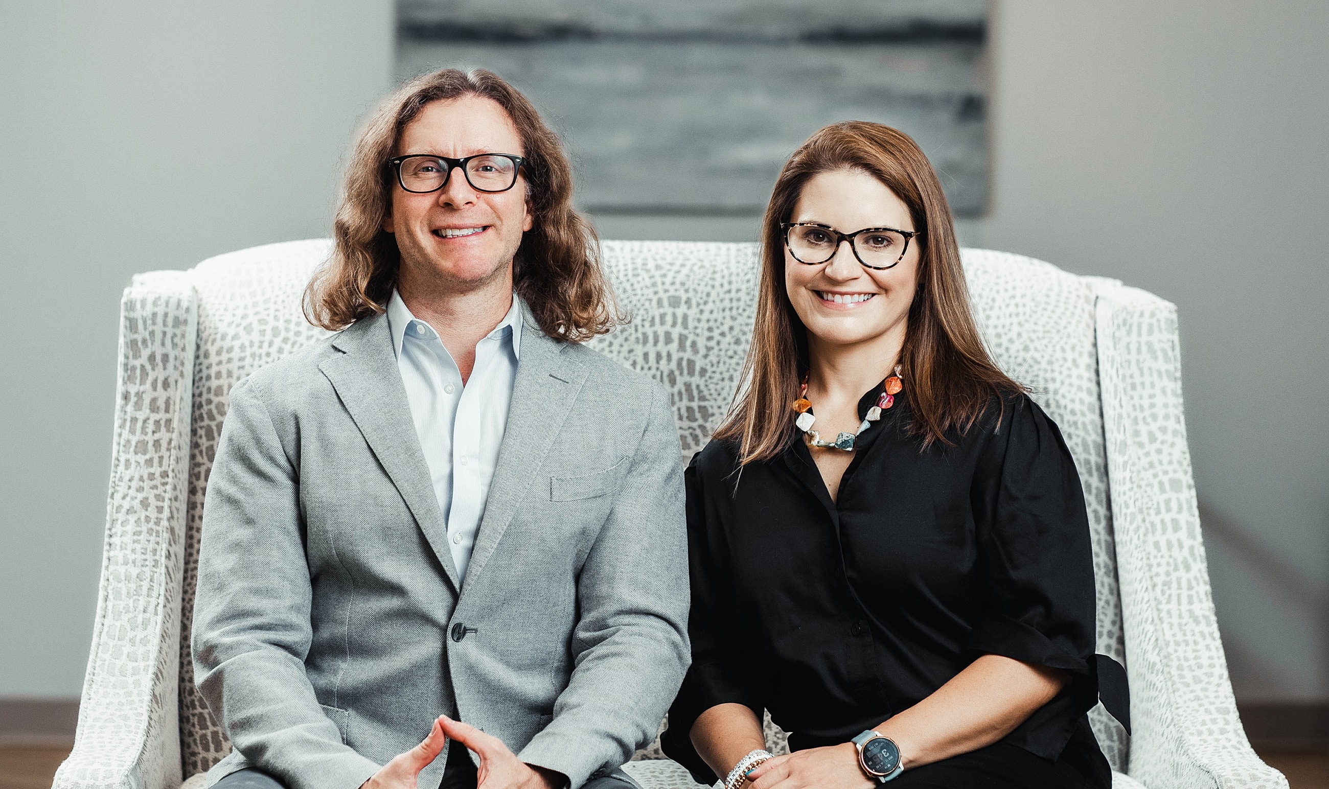 Two professionals sitting together in an office.